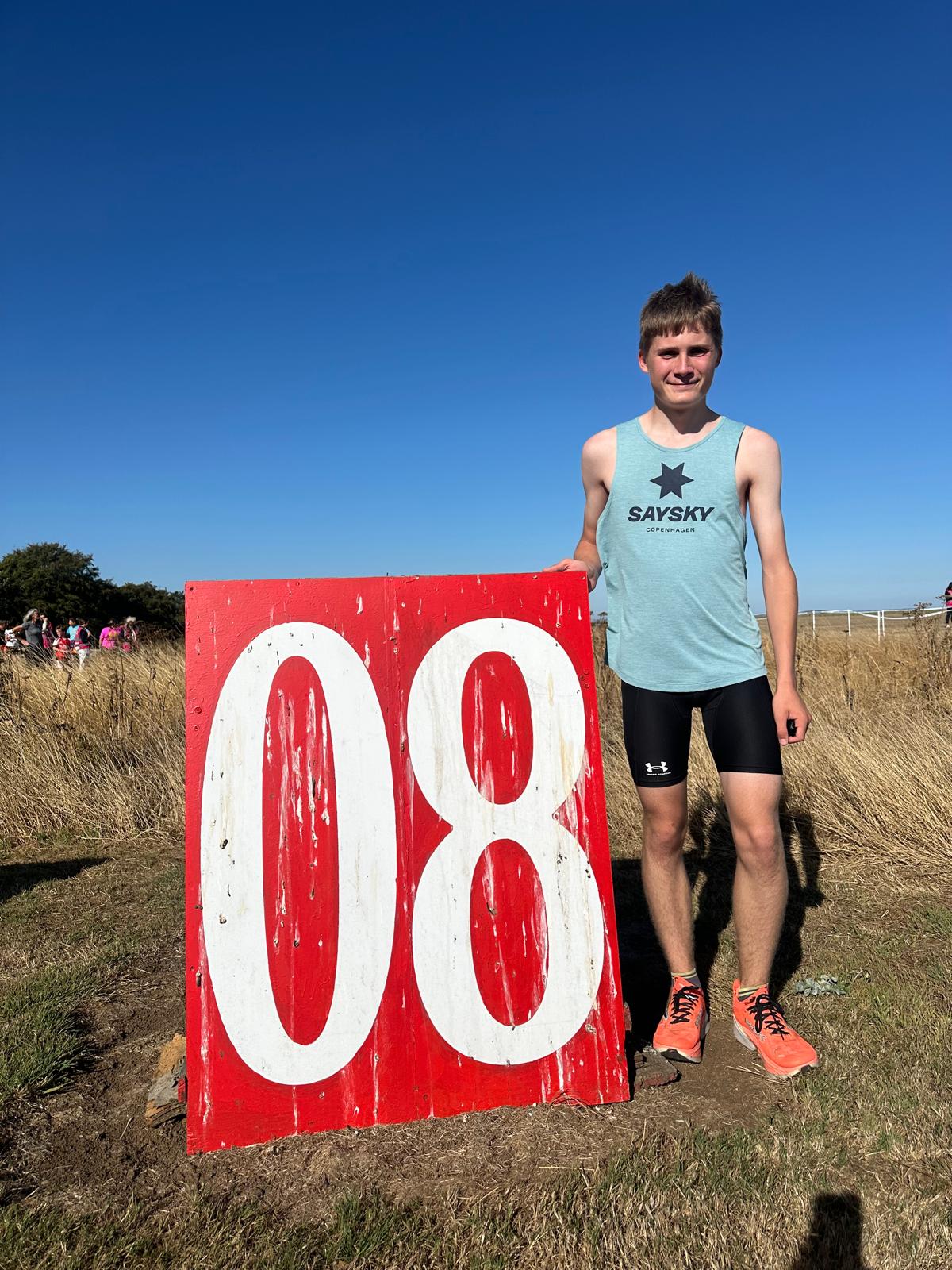 Jack Ainsley in SAYSKY kit beside the red 08 board